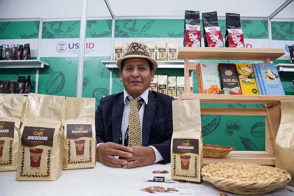 Pedro Ñahui Atao junto a productos de Café Ayacuchano en una feria